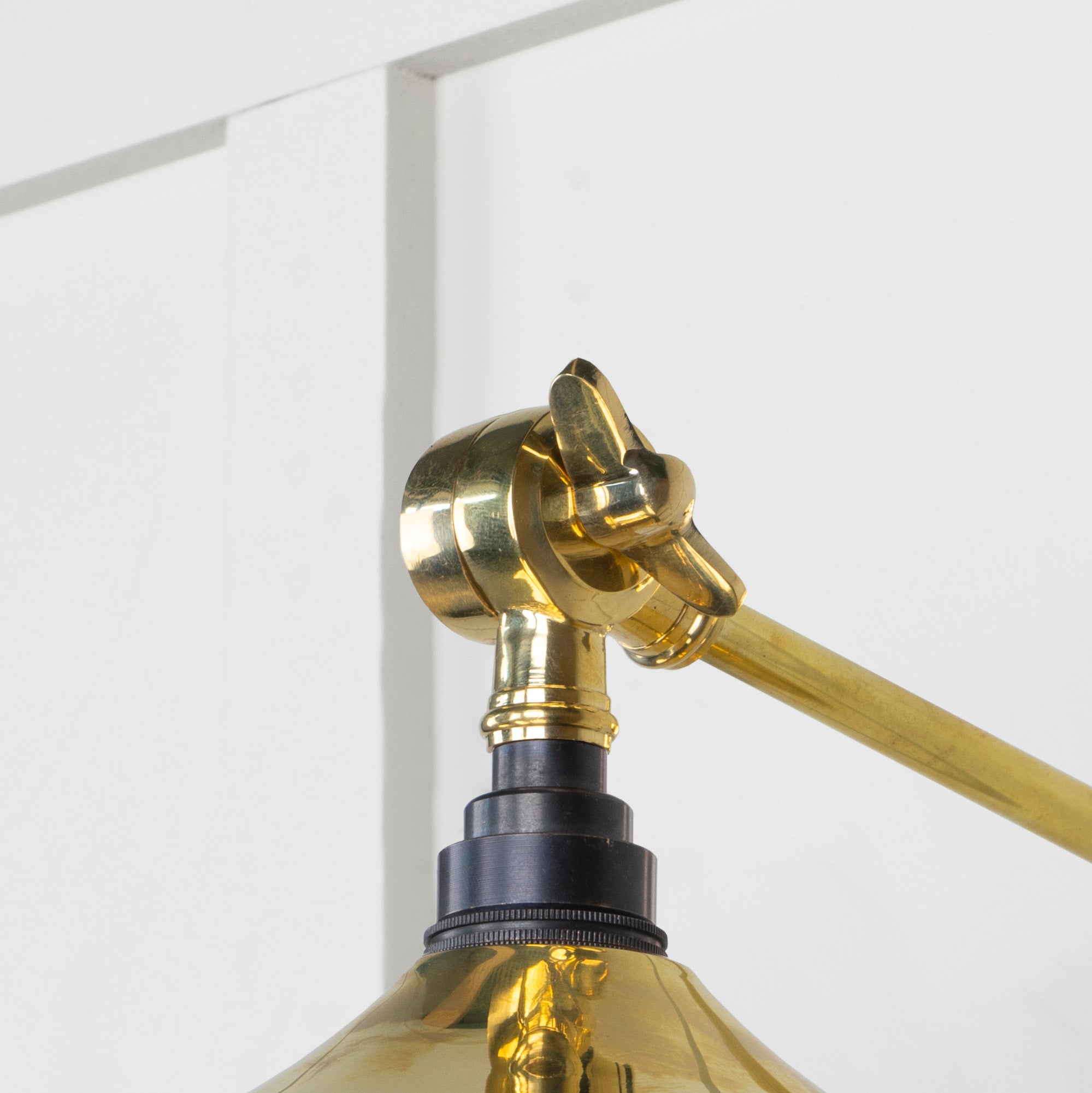 SHOW Close Up Image of Upper Hinge of Flora Wall Light in Brass