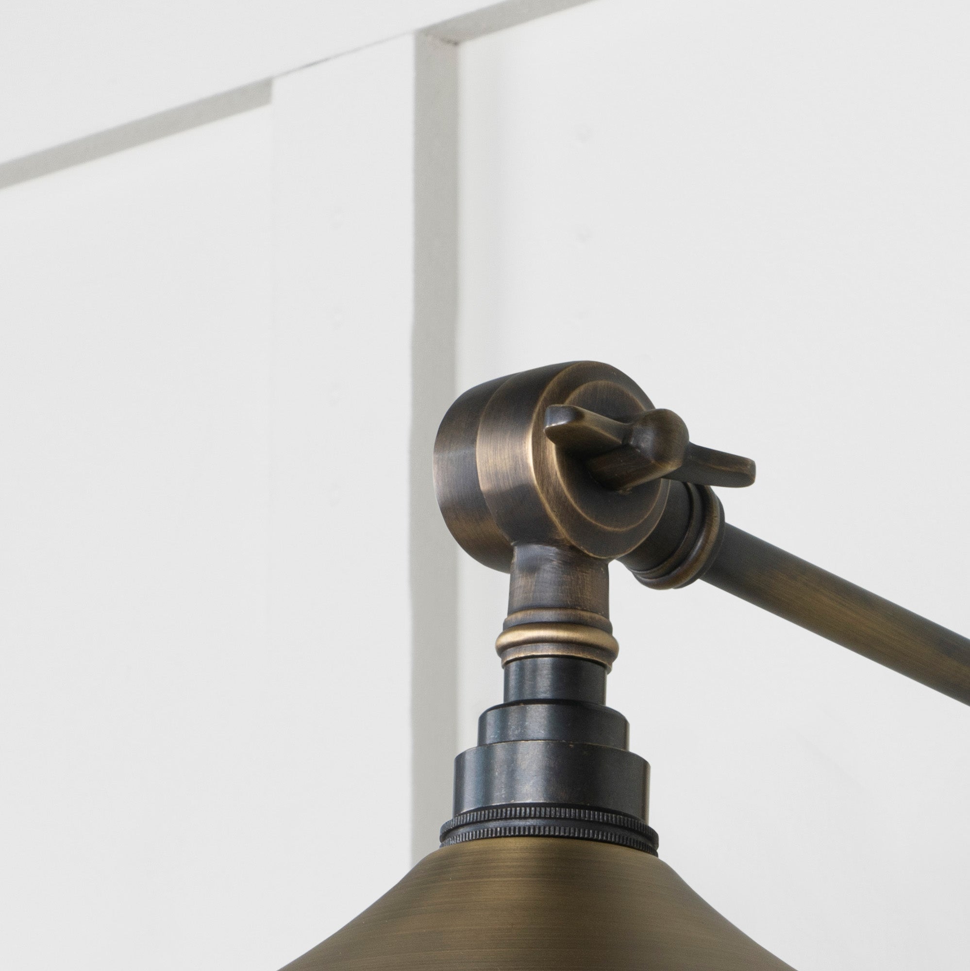 SHOW Close Up Image of Upper Hinge of Flora Wall Light in Aged Brass