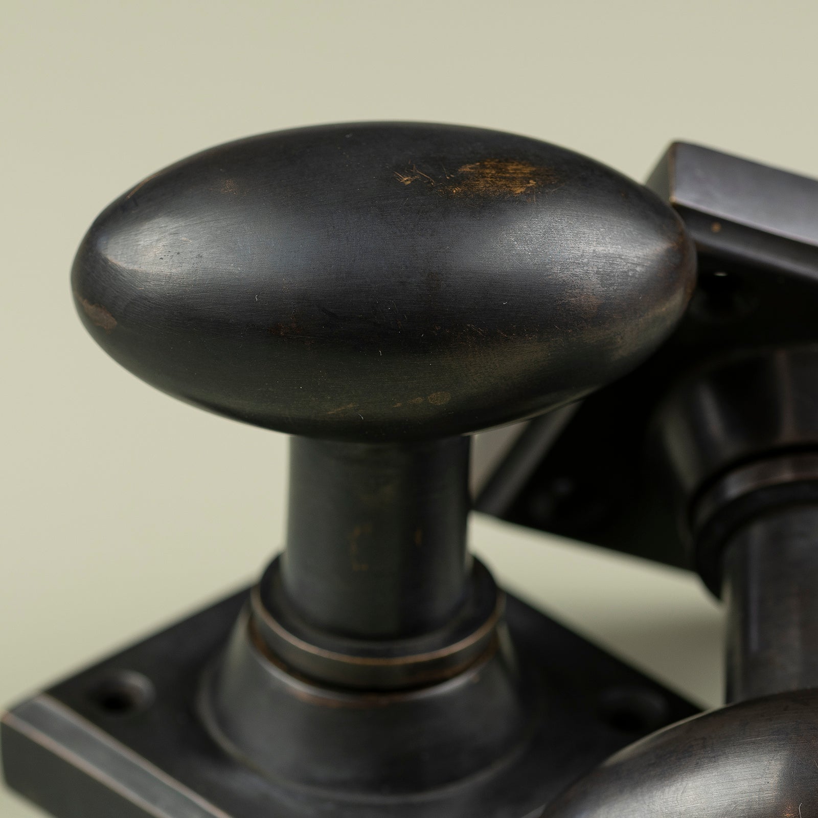 detail of oval bronze door knob SHOW