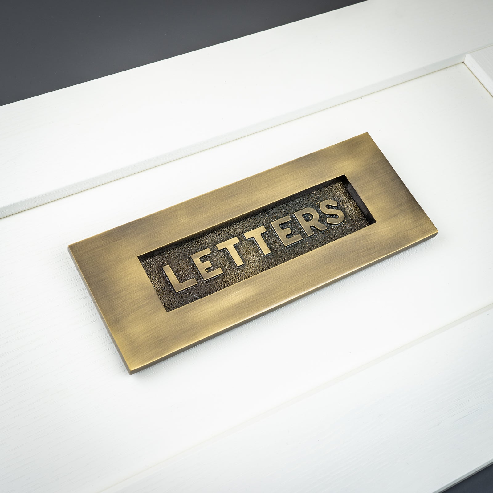 brass embossed letter plate SHOW