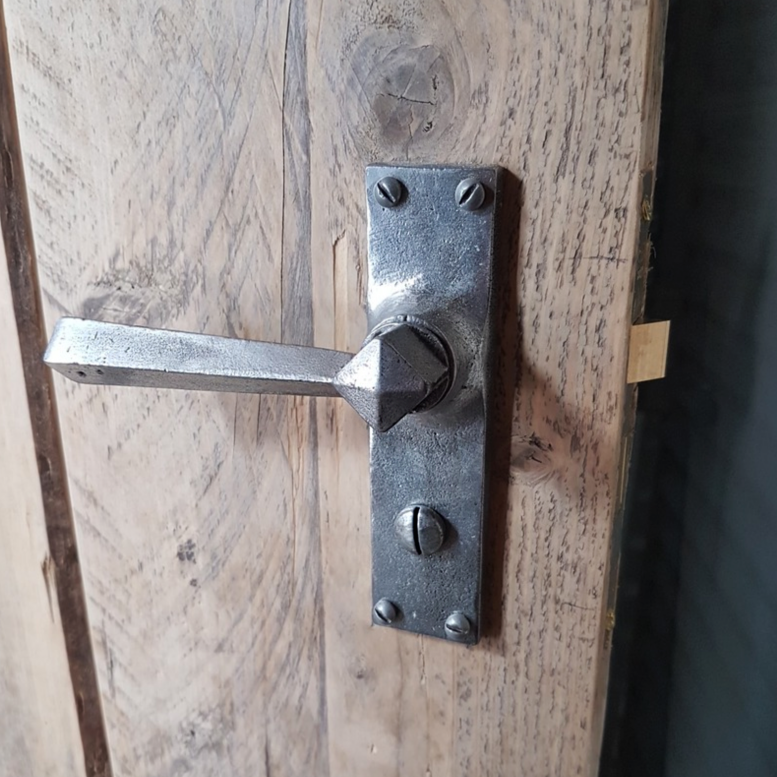 Pewter lever handle fitted to a door SHOW