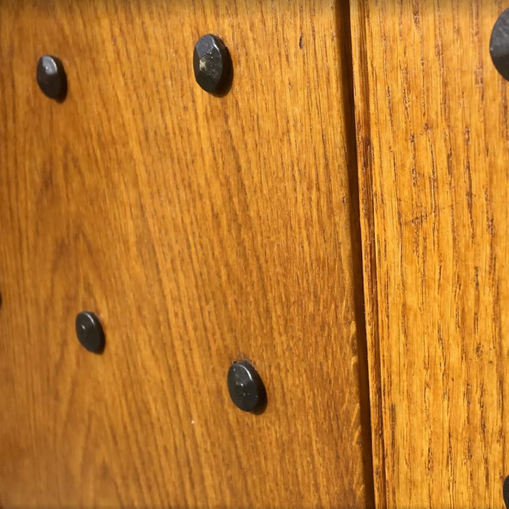 furniture studs, close up of door with decorative hand forged nails