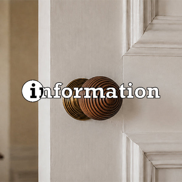 Rosewood beehive door knob on white painted door
