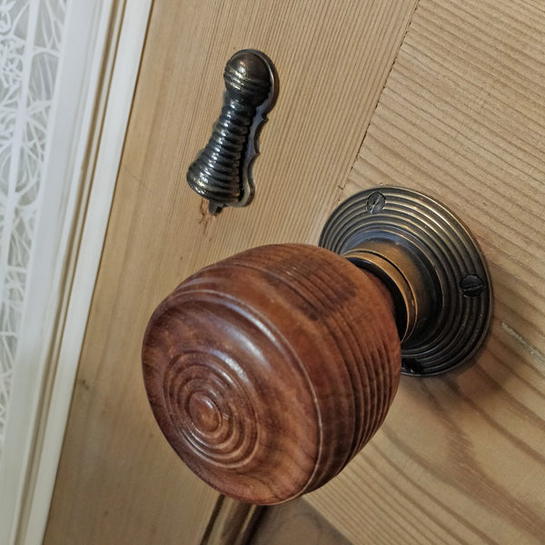 Georgian wooden door knob and brass beehive escutcheon