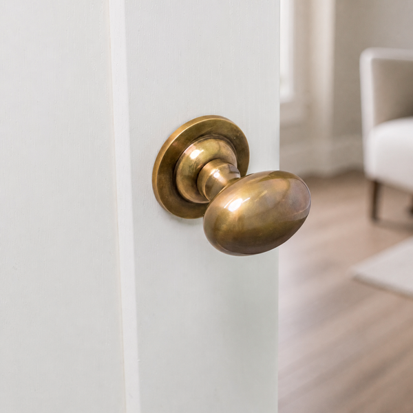  Antique Brass Oval Door knob on white door