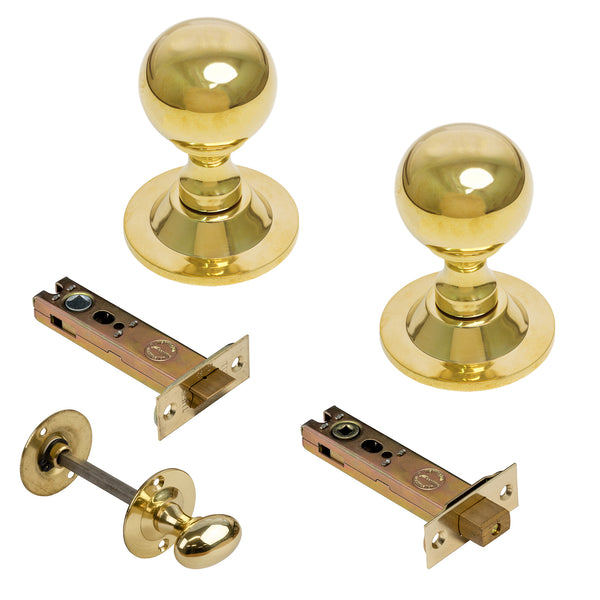  Two polished brass ball doorknobs with matching latch hardware pieces, shown on a plain white background.