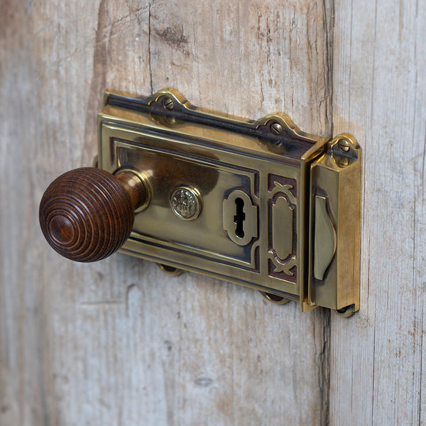  Lifestyle image of Ornate Antique Brass Rim Lock on wood