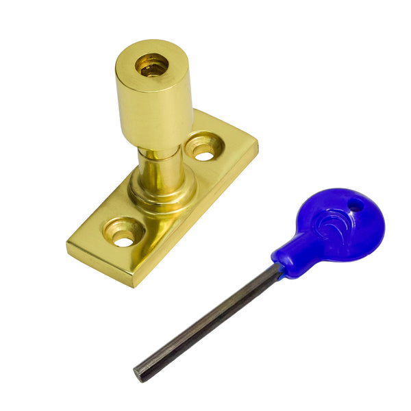  A polished brass sash stop with a matching flat mounting plate, shown alongside a blue-handled hex key on a plain white background.