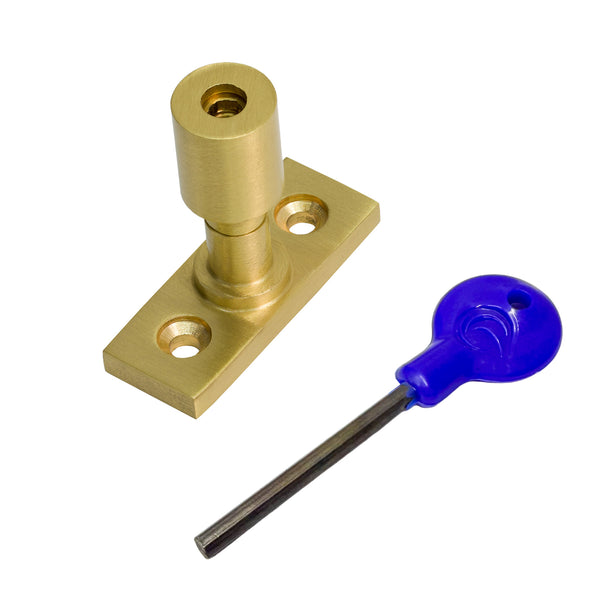  A satin brass sash stop with a matching flat mounting plate, shown alongside a blue-handled hex key on a plain white background.
