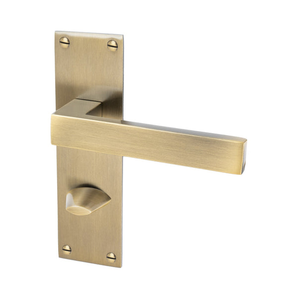 Metro Door Handles On Plate Bathroom Handle in Aged Brass