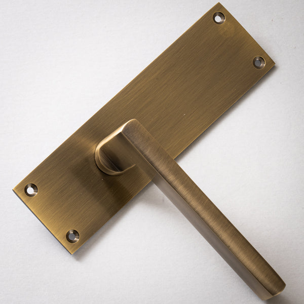 Trident Door Handles On Plate Latch Handle in Aged Brass 